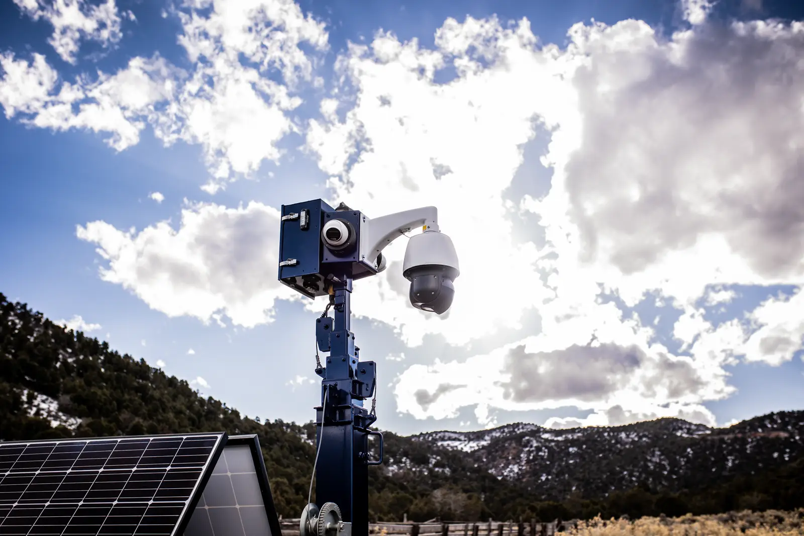 The Overwatch mast head: a fixed camera array and PTZ dome camera mounted above the trailer's solar panel.