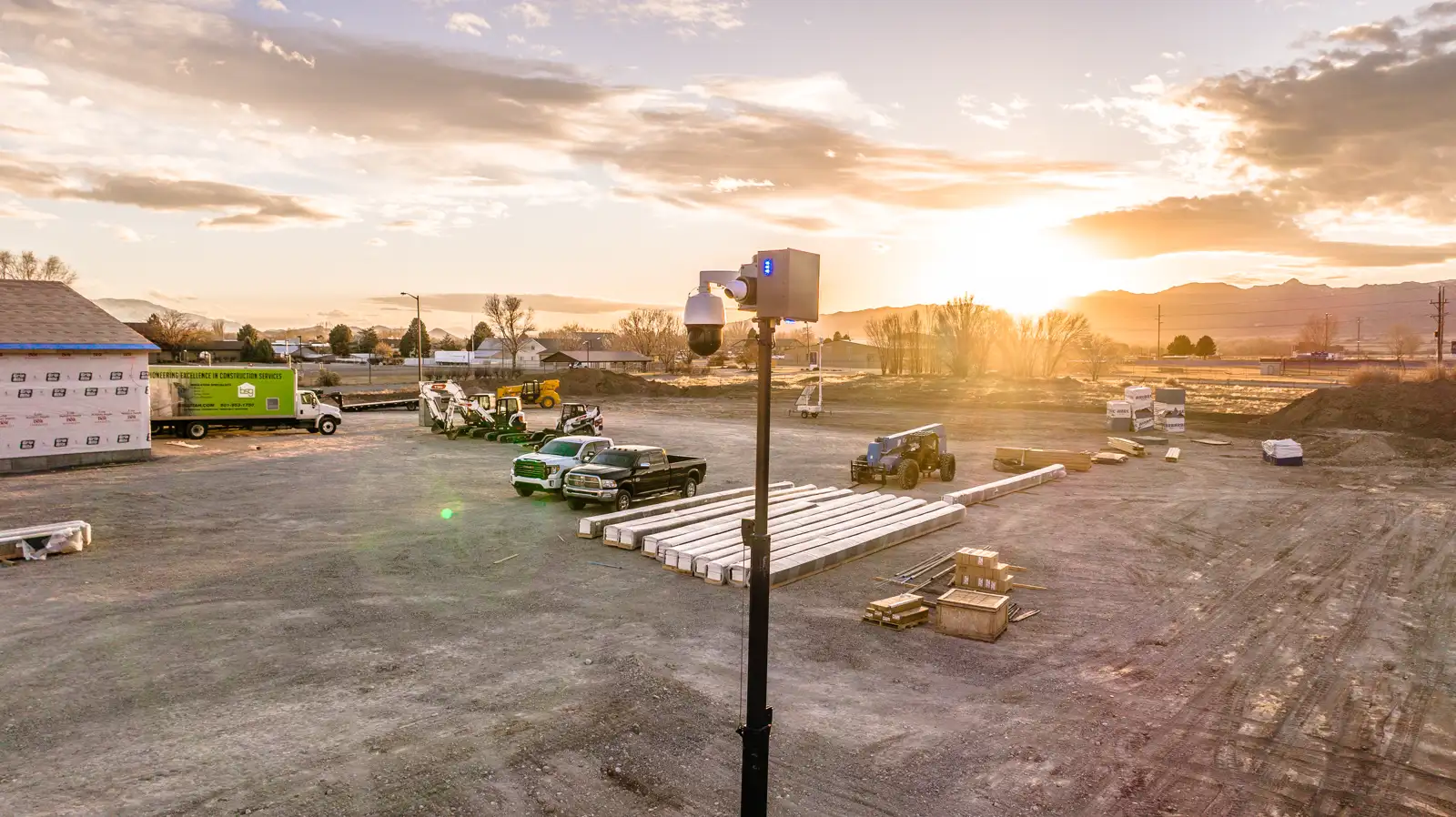 An Overwatch trailer on a jobsite at dusk, mast raised against the sunset.