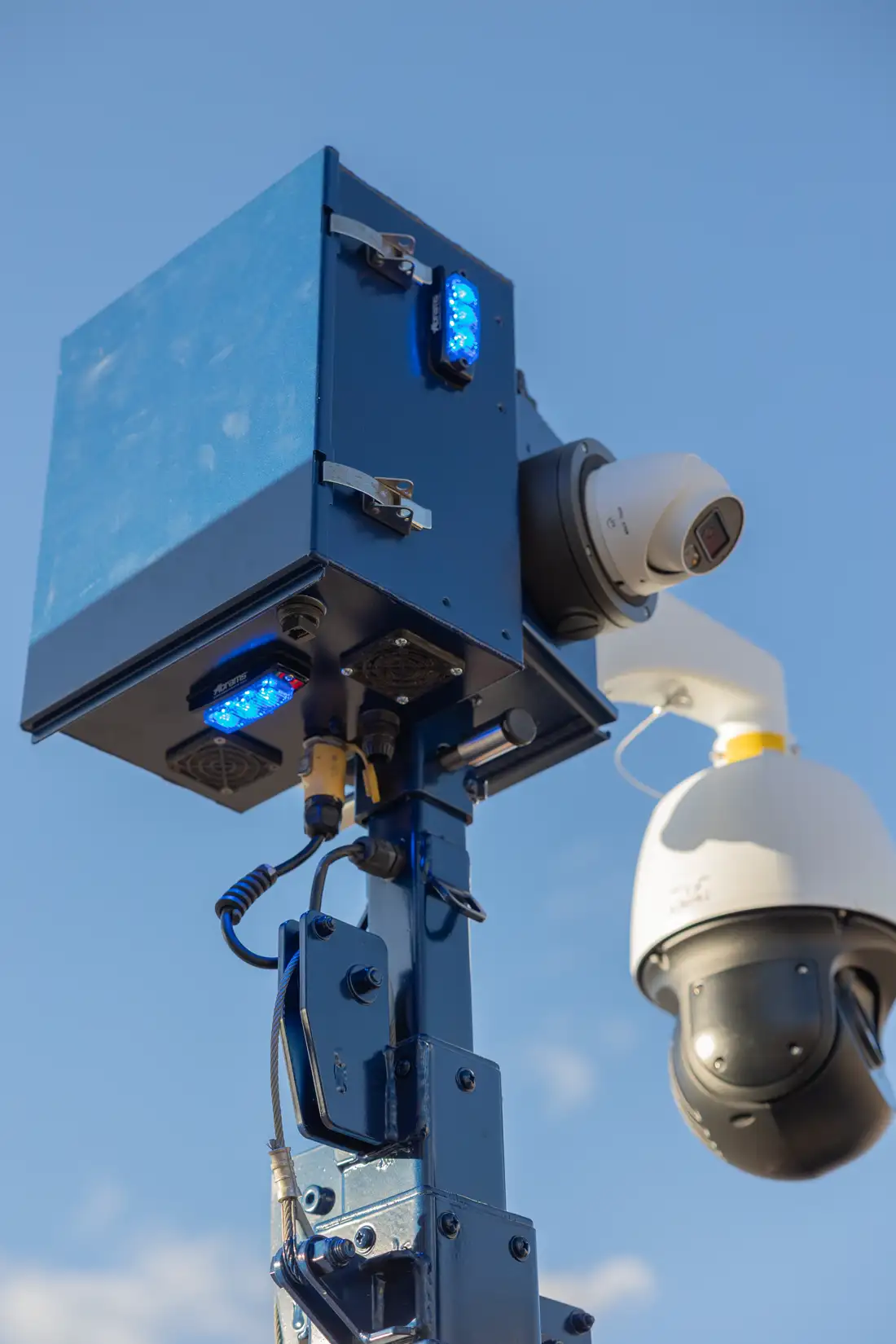Close-up of the mast head unit with fixed cameras and status light on.